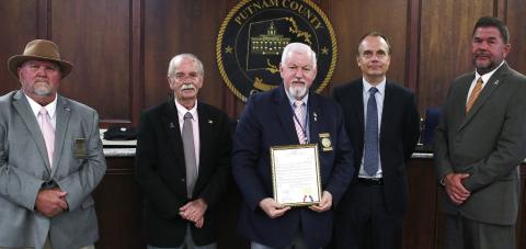 Putnam County Commission Chairman Bill Sharp holds a proclamation regarding Operation Green Light Putnam County, which encourages local citizens from Nov. 4-11, to “recognize the importance of honoring all those who made immeasurable sacrifices to preserve freedom by displaying green lights in a window of their place of business or residence.” IAN TOCHER/Staff