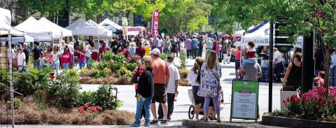 People walk the streets of downtown Greensboro while enjoying a previous, sunny Southland Jubilee. CONTRIBUTED