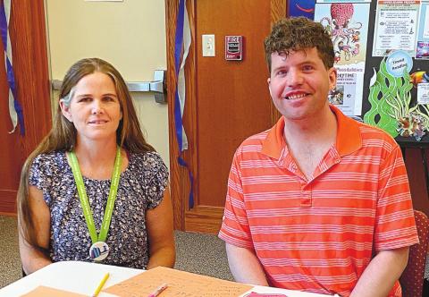 Tara Coile, Director of the Special Readers Program and volunteer Keith Granden at Saturday’s library event. MAUREEN STRATTON/Staff