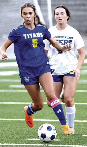 LOA senior Marley Dellinger (5) dribbles the ball away from a defender in a recent region matchup against Washington-Wilkes. SKYLA MORRIS/ Staff