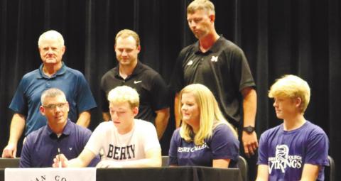 Coody signs his letter of intent to play collegiately at Berry College while his family, friends and coaches watch. KATIE MARIE O’NEAL/ S t a ff