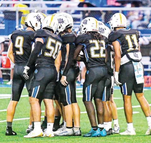 The Lake Oconee Academy defense huddles in between plays during a game against Brentwood Christian earlier this season. FILE PHOTO