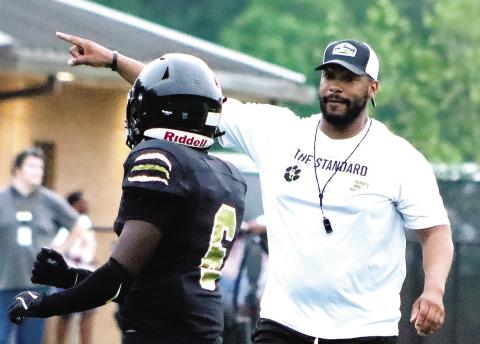 Greene County head coach Darius Robinson instructs one of his players during the team’s spring game in May. COURTESY OF MOMMA D’S PIX