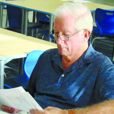 BOE Chairman Mike Lynch, who regularly attends LOA’s Board of Governors meetings, reviews financial records at Monday’s monthly meeting. MARK ENGEL/Staff