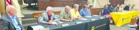 The Greene County Board of Education (left) and the Lake Oconee Academy Board of Governors at a special called meeting Monday night, prior to moving to separate rooms for a three-hour negotiating session on LOA’s lawsuit against the BOE. MAUREEN STRATTON/Staff