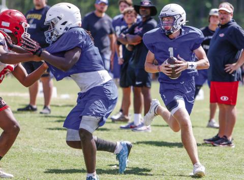 LOA quarterback Jake McDonald (1) rolls out of the pocket, looking to make a play downfield during last Thursday’s padded camp at Putnam County. LANCE McCURLEY/Staff