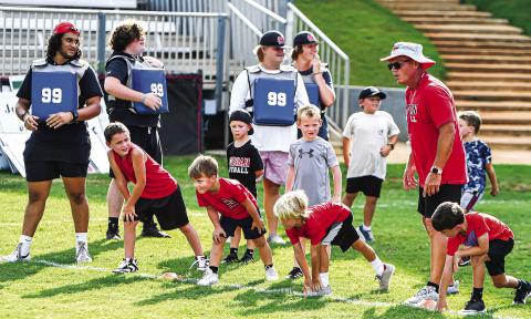 Four campers line up and get set to run sprints during a speed and agility drill. CHARLES JORDAN/Staff