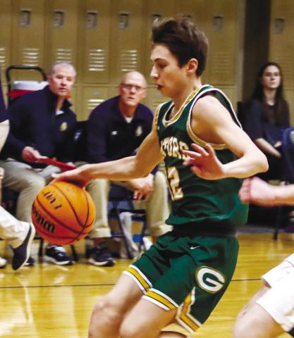 Gatewood freshman Matt Allen (12) dribbles the ball inside the lane in transition against the Lions. LANCE McCURLEY/Staff
