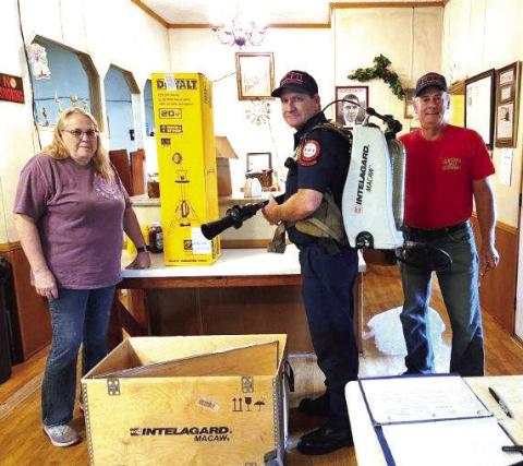 Last month, members of the Kinderhook Fire Association (KFA) donated a high-powered fire scene light and high-tech firefighting backpack to the Putnam County Fire Department. L-R: KFA Vice President Terea Jacobs with a PCFD firefighter and KFA President Elliott Perkins. CONTRIBUTED