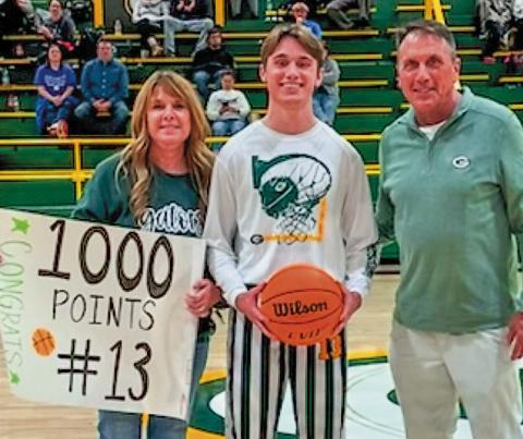 Gatewood senior Kaden Keiser, with parents Joni and Don, joined his grandfather last week as a 1,000-point scorer in high school hoops. IAN TOCHER/Staff