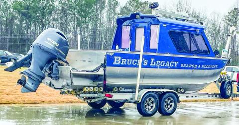 The Bruce’s Legacy boat is parked in the rain after owner Keith Cormican used it to locate the drowned body of Gary Jones on Lake Oconee. LYNN HOBBS/Staff