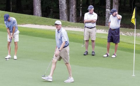 Tom Clements Jr., foreground, reacts to tournament onlookers as he plays The Oconee Cup tournament during the “Alternate Shot” format on the Oconee Course. LEIGH LOFGREN/Staff