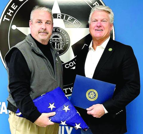 U.S. Rep. Mike Collins presents Sheriff Robert Markley (left) with a flag that was flown over the U.S. Capitol in honor of his time serving Morgan County. CONTRIBUTED