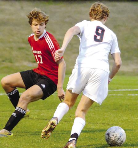 Carson Keener (17) eyes down Clarke Central senior Clayton Dufur (9) as he tries to dribble the ball away and take a shot from outside the box. LANCE McCURLEY/Staff
