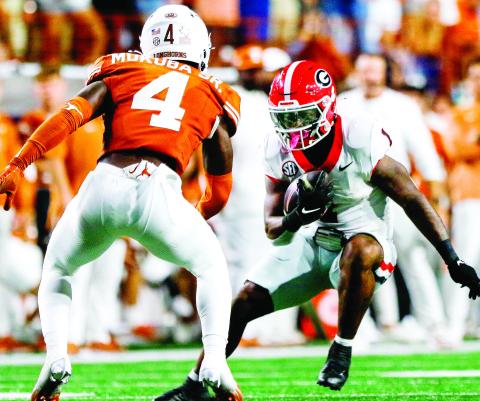 Georgia running back Trevor Etienne (1) accounted for all three Bulldog touchdowns in Austin. LANCE McCURLEY/Staff