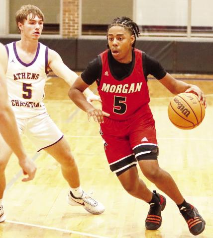 Jamauri Evans (5) drives inside the lane during a fast break in the third quarter against Athens Christian on Tuesday. LANCE McCURLEY/Staff