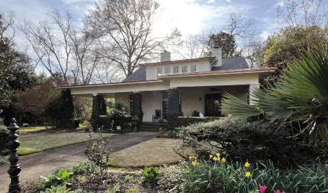 The WH Paul-Peeples house with its beautiful landscaping overtaking the front exterior view. CONTRIBUTED