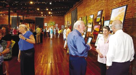 Many local art aficionados visited Barrel 118 in Eatonton to check out the art and socialize during the Juried Art Show.