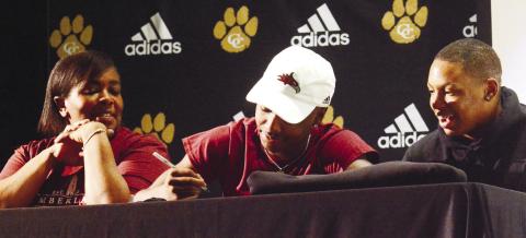 Greene County football player Arkiyus Wright signs his letter of intent to play at Cumberland University during a ceremony last week held on National Signing Day. BRENDAN KOERNER/Staff