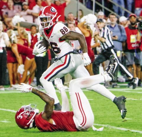 Georgia wide receiver Dillon Bell (86) runs over Alabama defensive back Keon Sabb (3) on his way to the end zone, giving the Bulldogs a 34-33 lead. LANCE McCURLEY/Staff