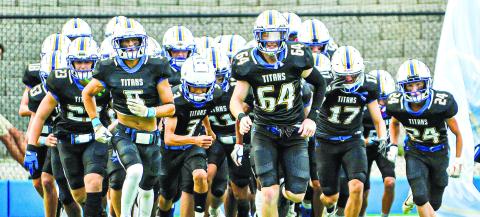 Lake Oconee Academy’s football team running out at the start this season at Titan Stadium. CHARLES JORDAN/Staff