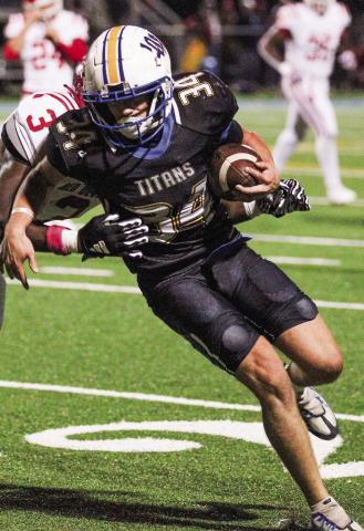 LOA junior Walker Poyner (34) tries to pick up some tough yardage as a Lincoln County defender tries to bring down him. WILL MORRISON/Staff