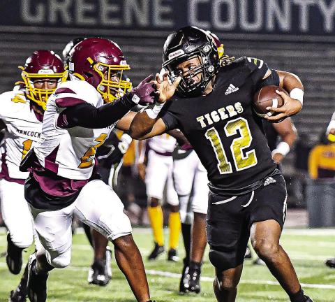 Tigers’ running back Armari Durham (12) runs past a Bulldog defender in last Friday’s home state playoff win. CHARLES JORDAN/Staff
