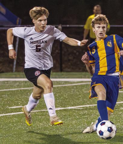 Morgan County’s Korbin Hedgwood (5) tries to battle for possession of the ball in a match against Lake Oconee Academy on Feb. 10. SKYLA MORRIS/Staff