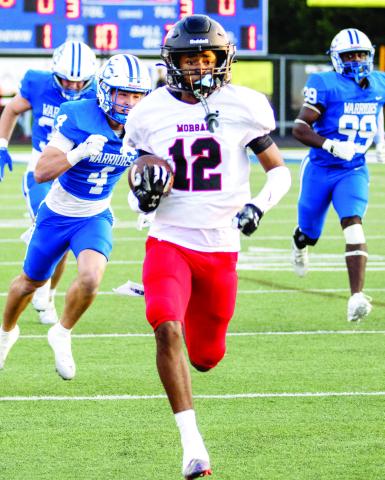 Morgan County senior wide receiver Jacoby Simmons (12) races down the field past Oconee County defenders on his 77-yard touchdown run on the Dogs’ first play from scrimmage this past Friday. SKYLA MORRIS/Staff