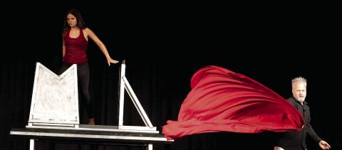 An assistant gets into the box ready for the show July 10 at Festival Hall. LEIGH LOFGREN/Staff