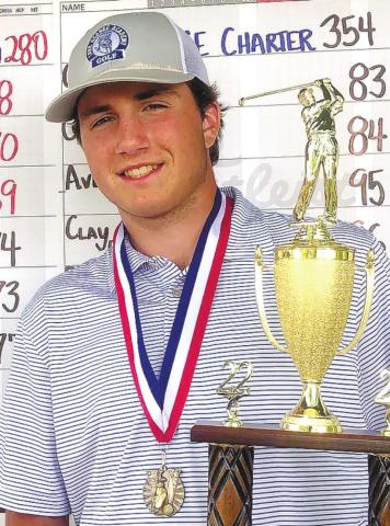 Colby Bennett with the boys’ lowmedalist trophy. CONTRIBUTED