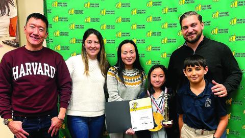 Lake Oconee Academy 4th-grade student Jordan Loh (third from right) advanced through 22 rounds of spelling competition last month to win the 2026 Greene County District Spelling Bee and advance to regional competition. CONTRIBUTED
