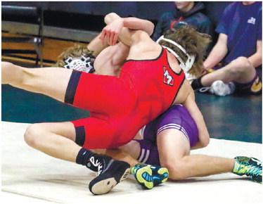 Sophomore Judson Carter, who wrestles in the 125-pound weight class, tries to pin an opponent. LANCE MCCURLEY/Staff