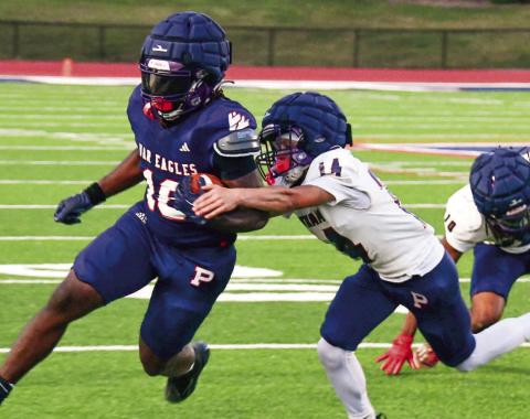 Putnam County running back Kumari Thomas tries to break a tackle during the team’s intrasquad scrimmage on May 15. IAN TOCHER/Staff