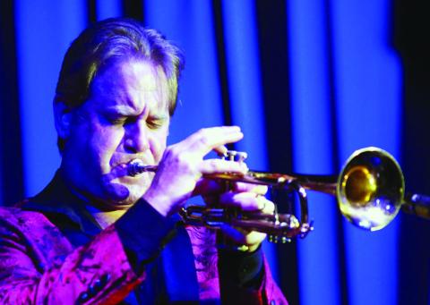 In addition to singing and leading the band, Gransden plays a mean trumpet. IAN TOCHER/Staff