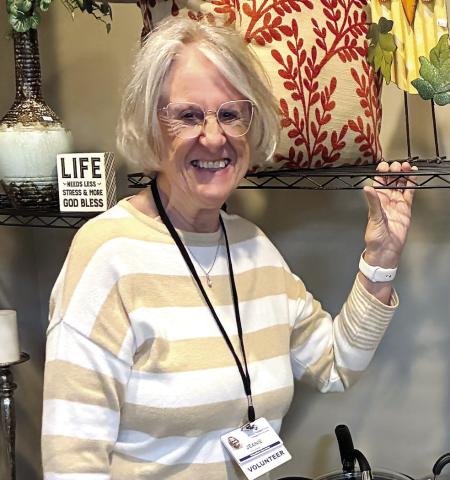 Volunteer Jeanie Wozniak poses with decorative and cooking items. CONTRIBUTED