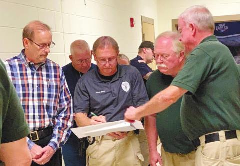 Discussing the entrances and exits of school rooms as they examine the high school’s floor plan are, from left, Eatonton Police Chief Howell Cardwell, Eatonton police Sgt. Harold “Buddy” Bowman and officer/certified instructor Nathan Mason, Putnam County Sheriff Howard Sills and Putnam County Sheriff’s Lt. Harry Luke. LYNN HOBBS/Staff