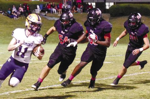 Morgan County’s Landen Vickers (54), Jamel Cox (50) and Brody Jenkins (10) chase down ARC quarterback Brooks Dickinson (11) in a 56-7 win over the Musketeers on Sept. 29. LANCE McCURLEY/Staff