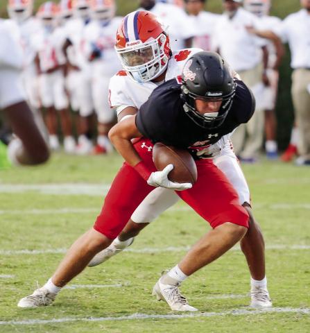Morgan County wide receiver Wyatt Singleton attempts to break away from a Cedar Shoals defender after hauling in a pass from quarterback Davis Strickland. JIM TURNER/Contributed