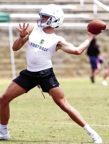 Lake Oconee Academy quarterback Ike O’Neal drops back to pass during a 7-on-7 camp at Athens Academy in June. O’Neal helped the Titans defeat Cherokee Christian in an Aug. 2 scrimmage, passing for 250 yards. LANCE McCURLEY/ Staff
