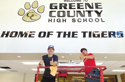 A pair of workers from 44 Signs get set to put up Greene County High School’s new ‘Ring of Honor’ wall. CONTRIBUTED