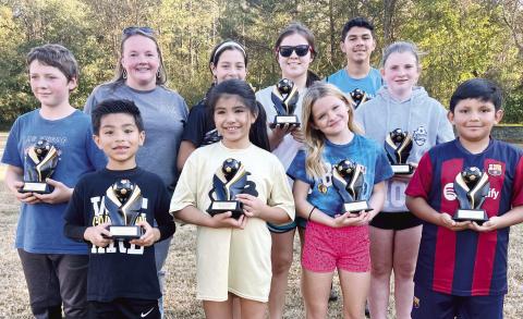The first-place winners in the State Soccer Shoot photo (back row, l-r):  Thomas Partee (Lake Oconee first place State), State Chair Bethany Jackson from Cartersville, Georgia, Rosa Nava, Isabella Nava, Isai Moreno and Brianna Goss;  (front row) Milan Guevara, Nicole Guevara, Charlee Clayton (Lake Oconee first place State) and Emanuel Cruz.
