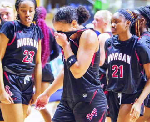 Morgan County senior guard Jaden Young (center) was emotional after the loss to Murray County. She was instrumental in helping the Lady Dogs attempt a comeback and led them in scoring with 31 points. LANCE MCCURLEY/Staff