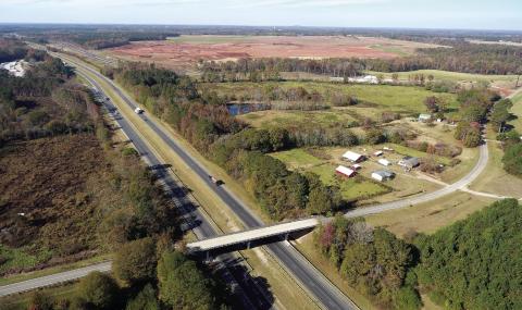 Grading work is underway on the 2,000-acre site where Rivian plans to build an electric vehicle manufacturing plant on the border of Morgan and Walton counties. Also visible is a frontage road, which will connect to a new exit on I-20, seen far left. MARK ENGEL/Staff