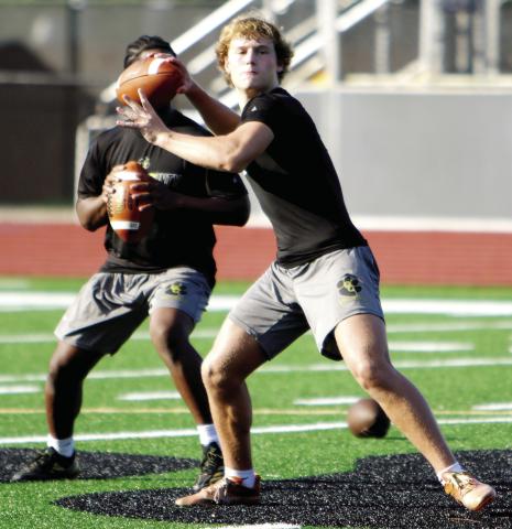 Greene County rising senior quarterback Landon Garretson gets set to fire a pass from the pocket during a practice on Monday. LANCE McCURLEY/Staff