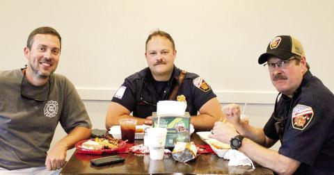 Local firefighters shared a little camaraderie while enjoying a complimentary barbeque lunch last Saturday at Farmview Market of Madison. SKYLA MORRIS/Staff