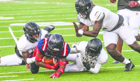 A group of Greene County defenders bring down Putnam’s Kaleb Crawford (9) out wide to keep him from breaking off a long run. BRENDAN KOERNER/Staff