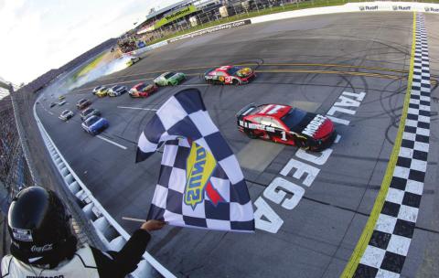 Ross Chastain, driver of the #1 Moose Fraternity Chevrolet, takes the checkered flag to win the Cup Series GEICO 500 at Talladega Superspeedway Sunday. (James Gilbert/Getty Images)