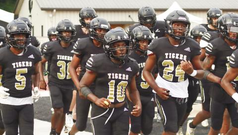 The 2023 Tigers running out to take on the Washington County Golden Hawks for the team’s spring scrimmage. BRENDAN KOERNER/Staff