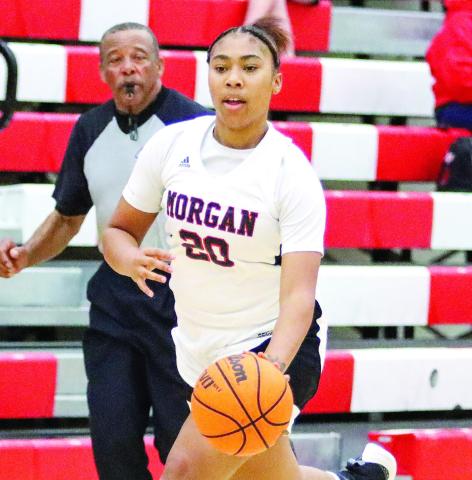 Morgan County senior Precious Benford (20) pushes the ball up the floor in a win over Salem. LANCE McCURLEY/Staff